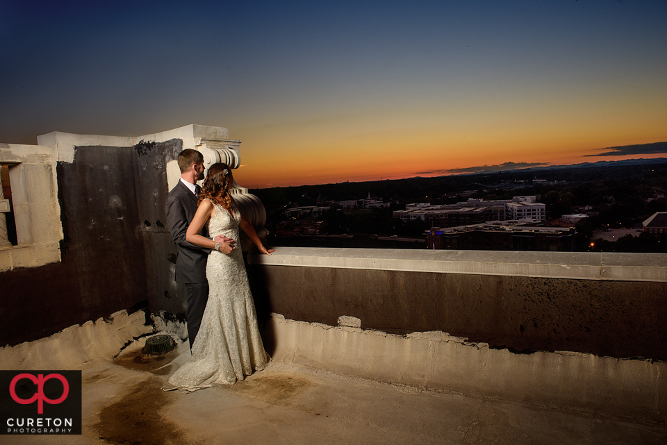 Bride and groom viewing the sunset from the rooftop of the Westin Poinsett during their wedding.