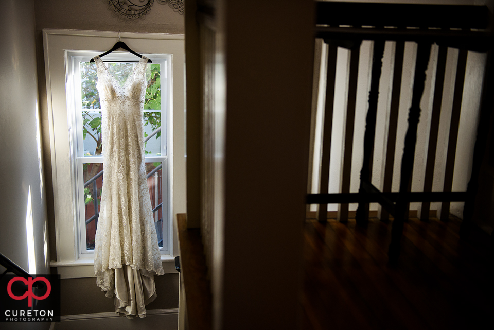 Brides dress hanging at Capella salon.