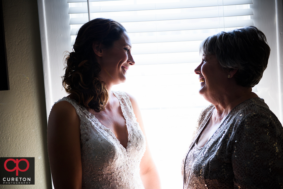Beautiful bride sharing a moment with her mother before her wedding at St. Mary's in downtown Greenville.