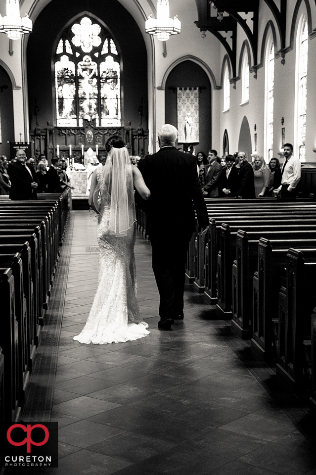 Bride and her father walking down the aisle at St. Mary's Catholic Church in Greenville South Carolina.