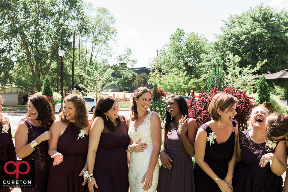 Bridesmaids laughing after the wedding at the playwright in Greenville South Carolina.