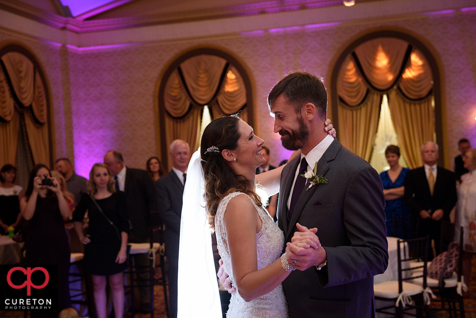Bride and groom sharing the first dance in the gold room at the Westin.