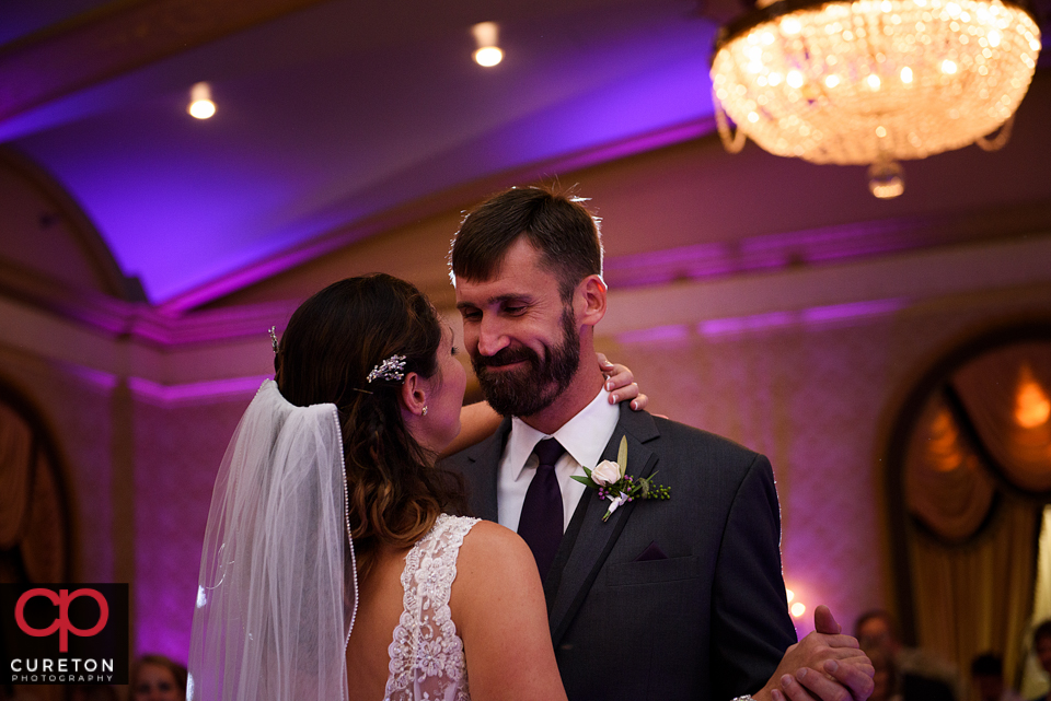 Groom smiling at his bride during their first dance at their Westin Westin Poinsett reception.