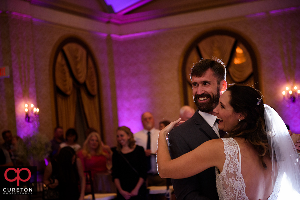 Briding groom laughing on the dance floor.