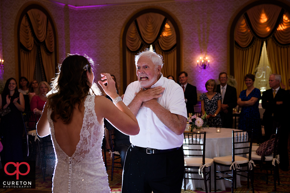 Father dancing with his daughter at the wedding.