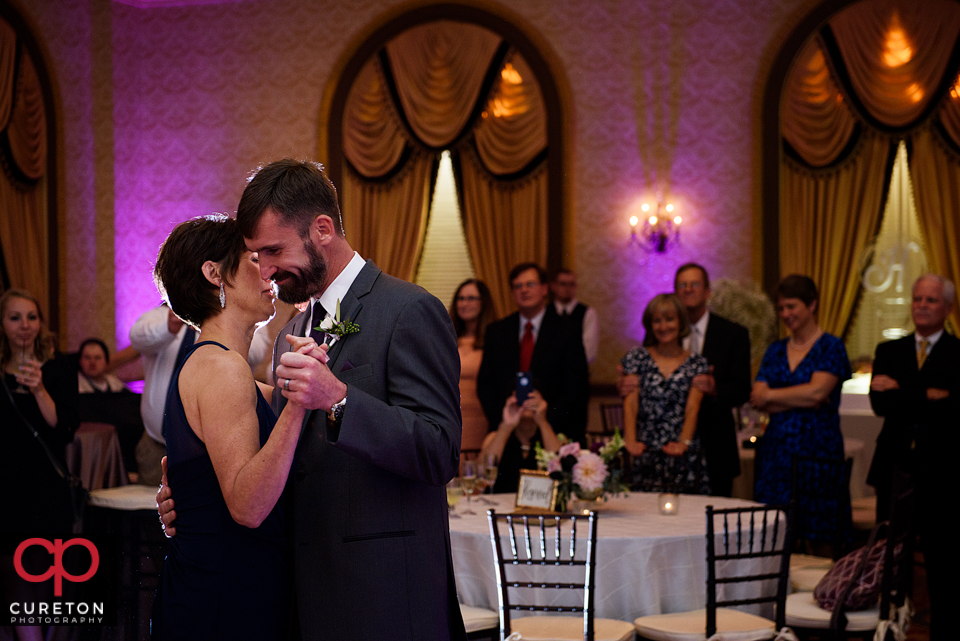 Groom dancing with his mother at the reception.ing with his mother at the reception.