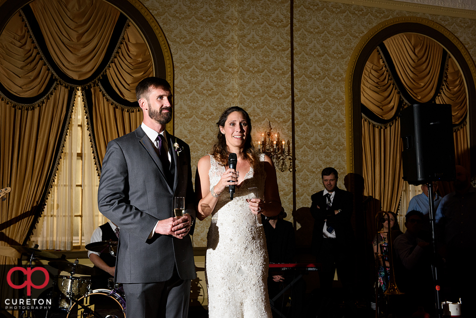 Bride and groom welcoming guests to the wedding reception.