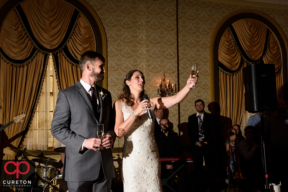 Bride raising a toast to her guests.