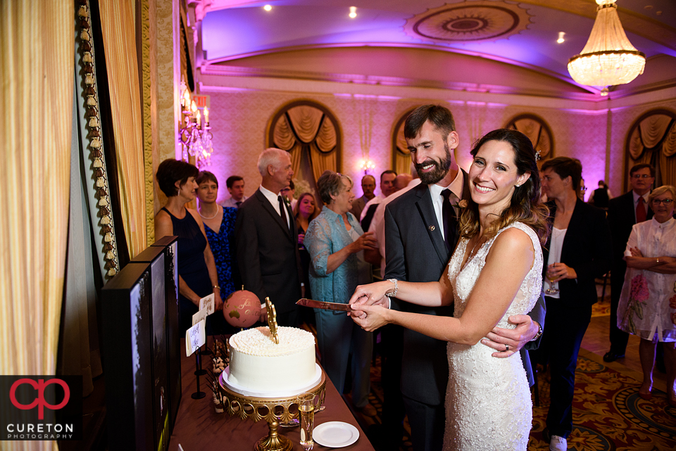 Bride and groom cutting the cake.