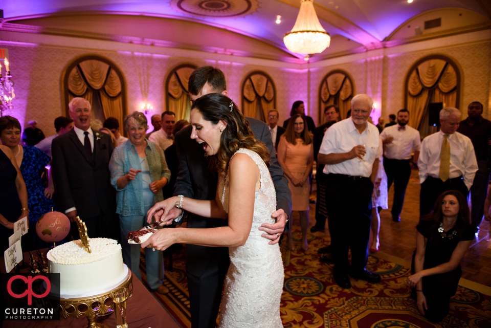 Briding groom cutting the cake.