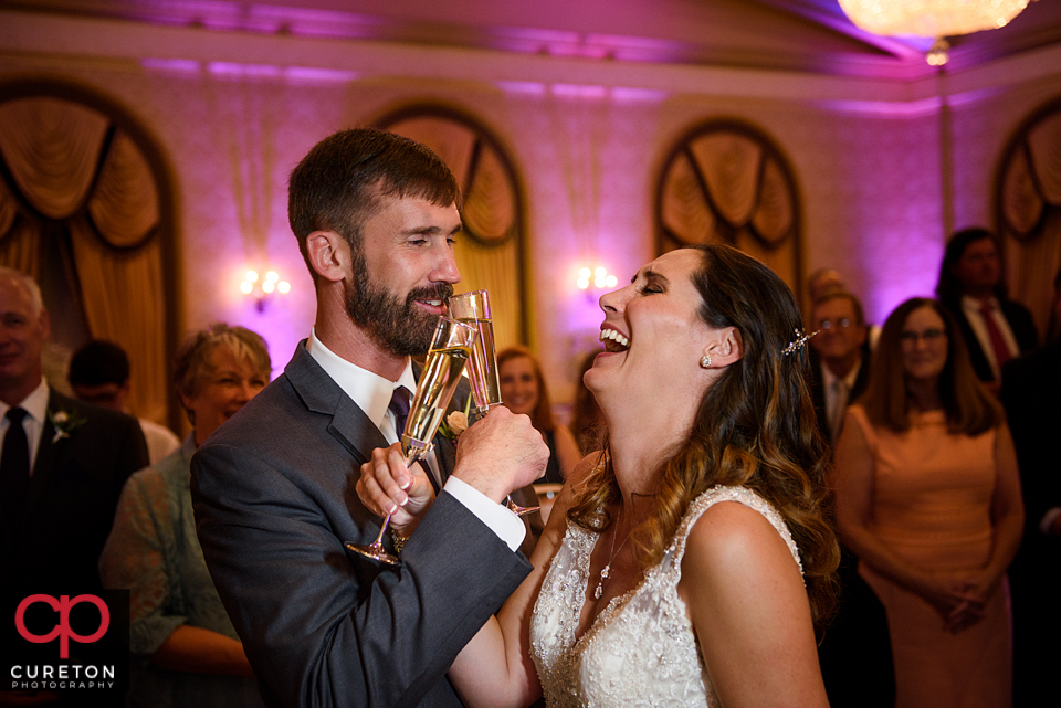 Bride and groom toasting at their wedding.