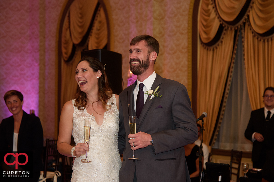 Bride and groom laughing during the toast.