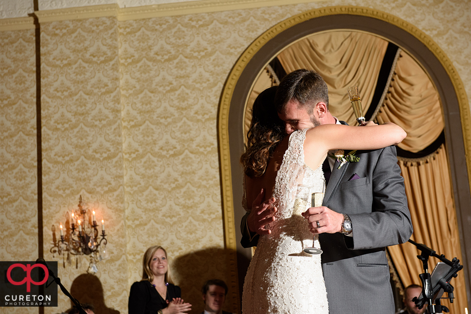 Bride and groom hugging.