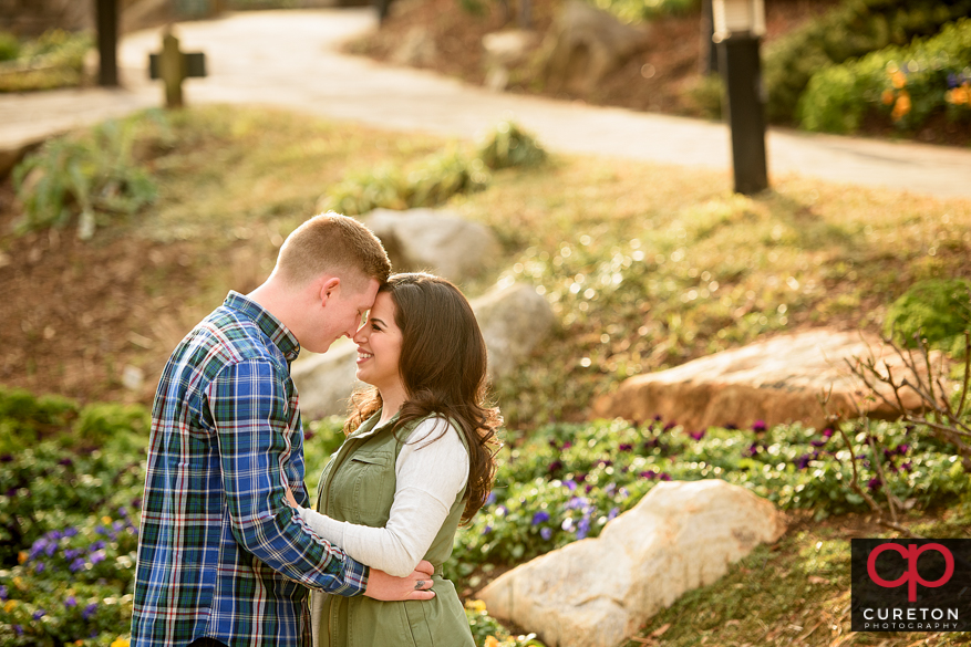 Man and woman forehead to forehead during an engagement session.