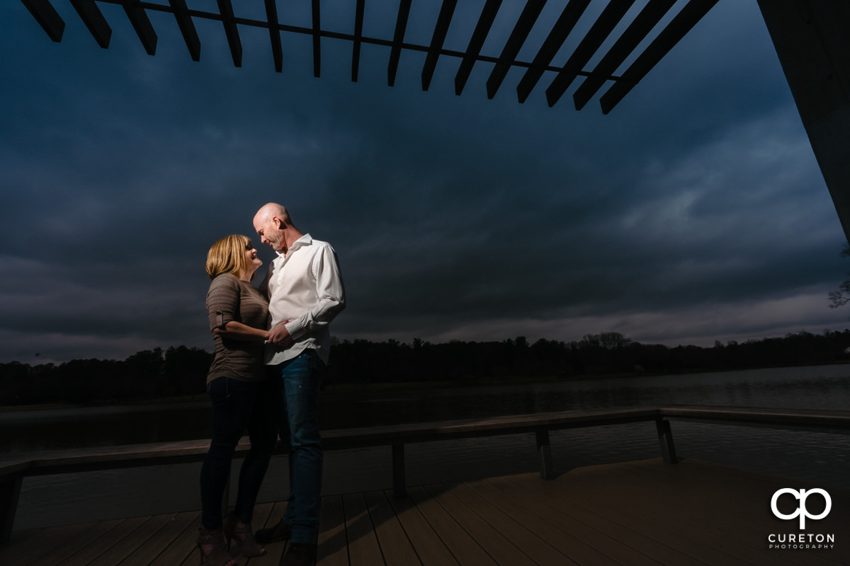 Engaged couple dancing by the lake during a Furman University Engagement session in Greenville,SC.