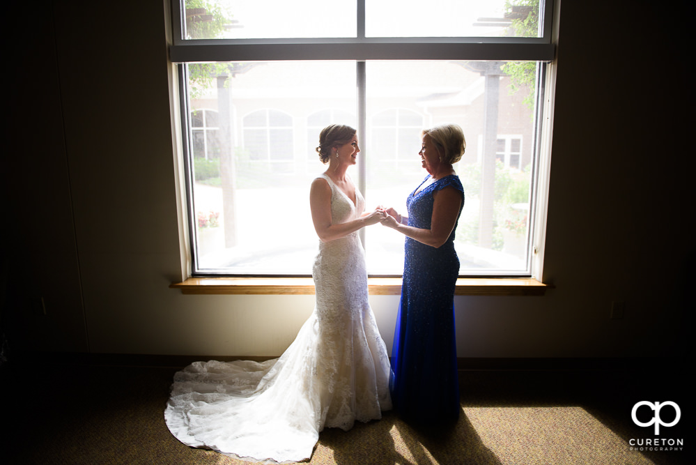 Bride and her mother sharing a moment before the ceremony at Covenant United Methodist Church.