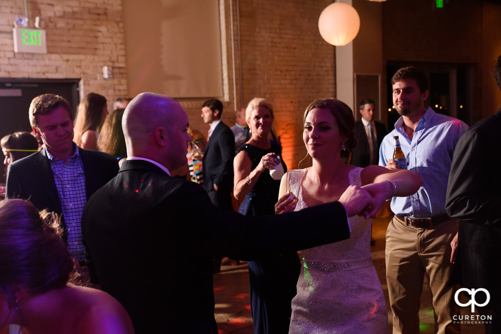 Wedding guests dancing at the reception.